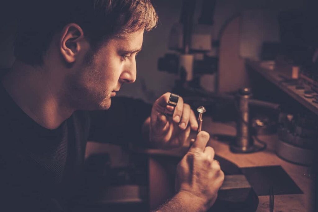 jeweler looking at the ring through microscope in 2021 08 26 16 21 10 utc min