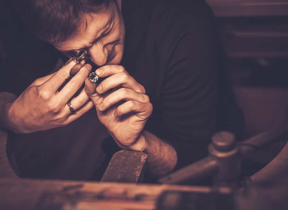 portrait of a jeweler during the evaluation of jew 2021 08 26 16 21 10 utc min